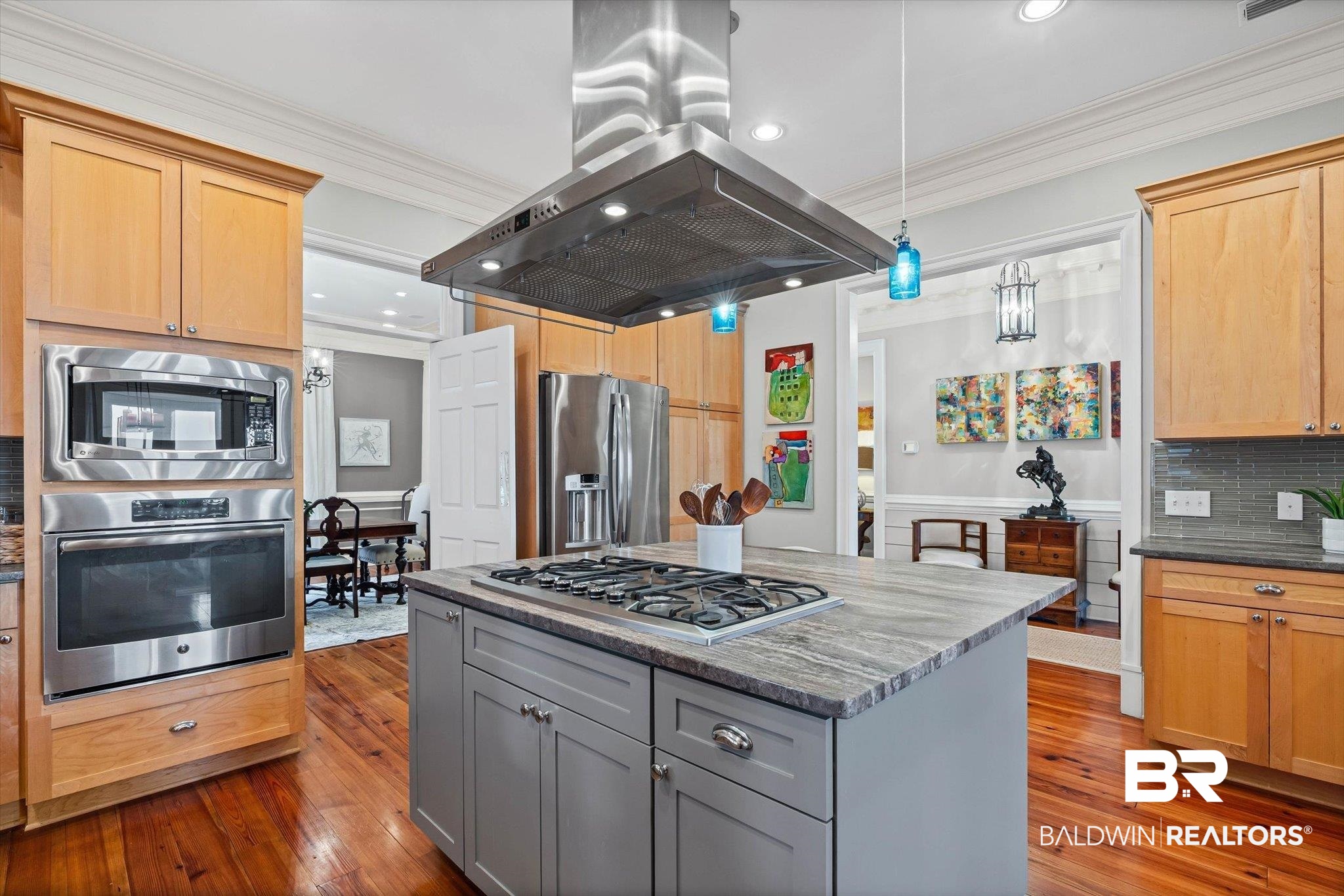 7015 Bay Road Mobile, AL 36605 - Photo 8 of 53 Kitchen with gray cabinetry, ornamental molding, island range hood, stainless steel appliances, and tasteful backsplash