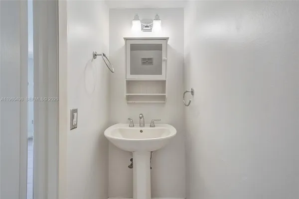 a white toilet sitting next to a white wall