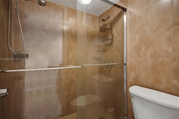 a bathroom with a shower and a toilet