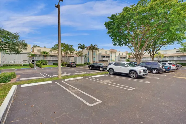 a cars parked in front of a house with a yard