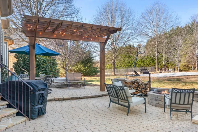 a view of a patio with a table chairs and a backyard