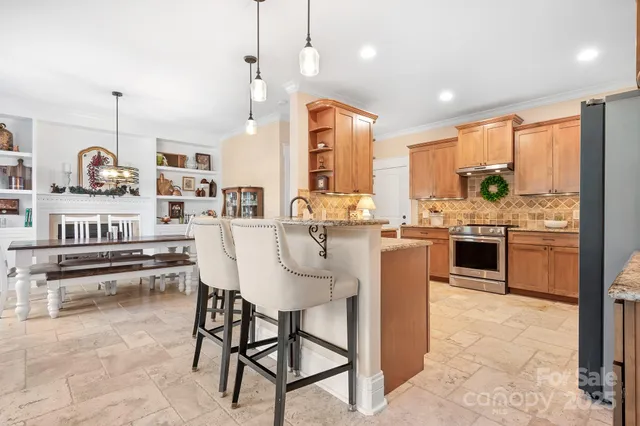 a kitchen with stainless steel appliances kitchen island granite countertop a sink and cabinets