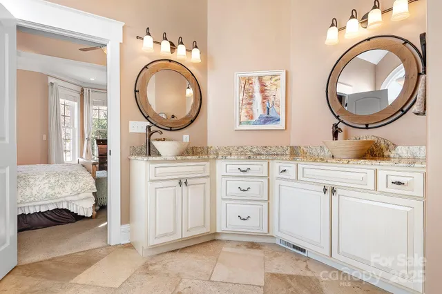 a bedroom with a sink and a mirror