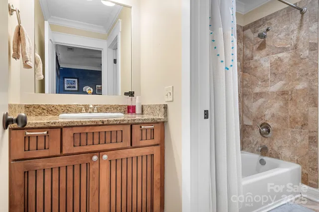a bathroom with a granite countertop tub and a sink