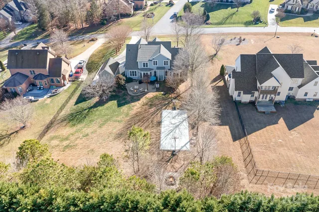 an aerial view of a house with a yard