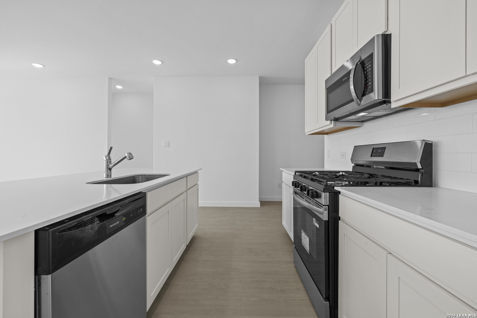 1895 Nuthatch Ridge New Braunfels, TX 78130 - Photo 2 of 20 a kitchen with stainless steel appliances a sink stove top oven and cabinets