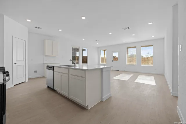 a large white kitchen with a large window