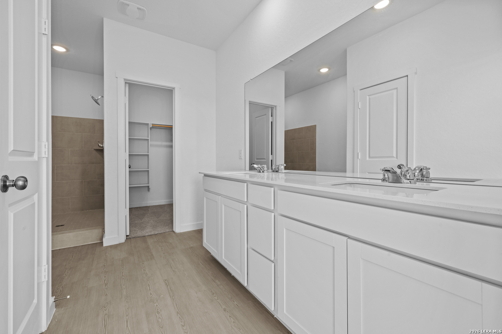 1895 Nuthatch Ridge New Braunfels, TX 78130 - Photo 10 of 20 a bathroom with a double vanity sink and mirror