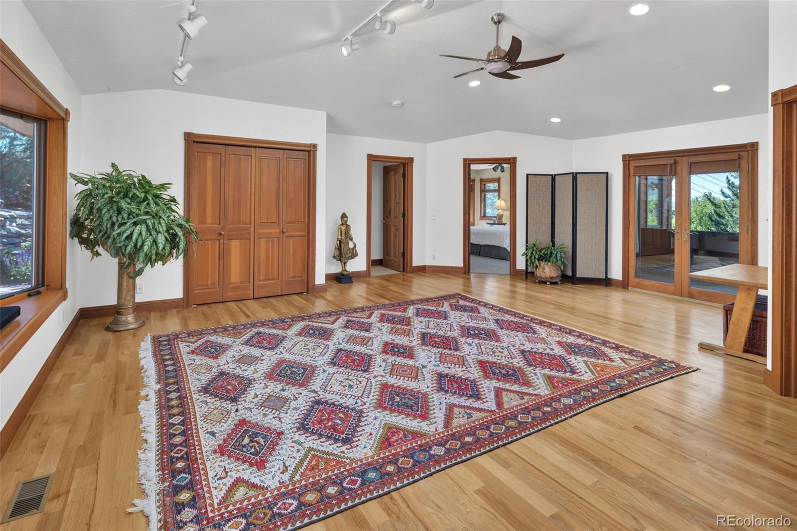3816 Cloverleaf Drive Boulder, CO 80304 - Photo 20 of 35 a view of a hallway with wooden floor and a chandelier
