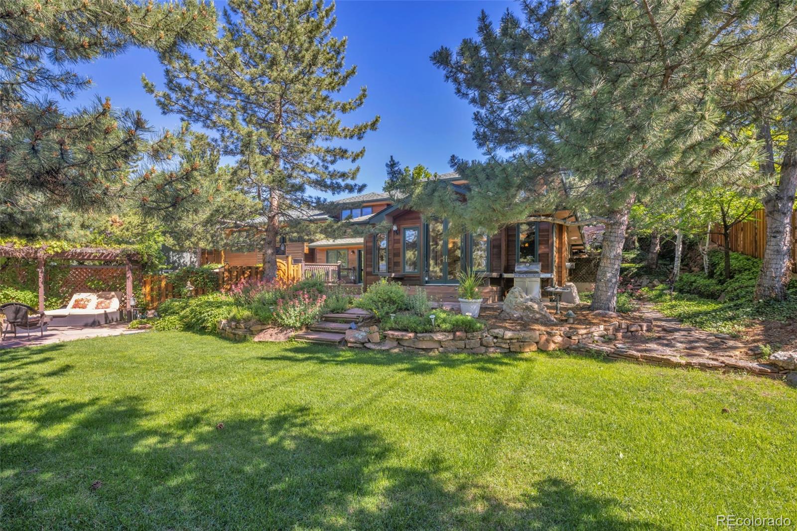 3816 Cloverleaf Drive Boulder, CO 80304 - Photo 2 of 35 a view of a patio with table and chairs under an umbrella