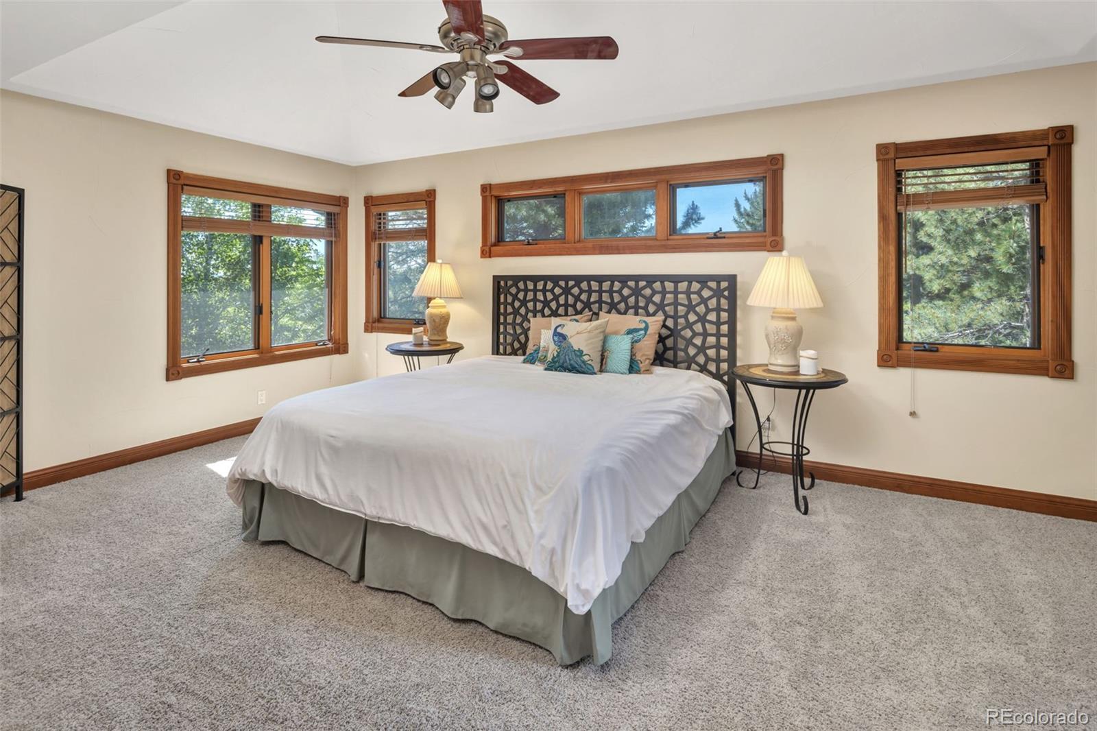 3816 Cloverleaf Drive Boulder, CO 80304 - Photo 21 of 35 a spacious bedroom with a large bed and a chandelier