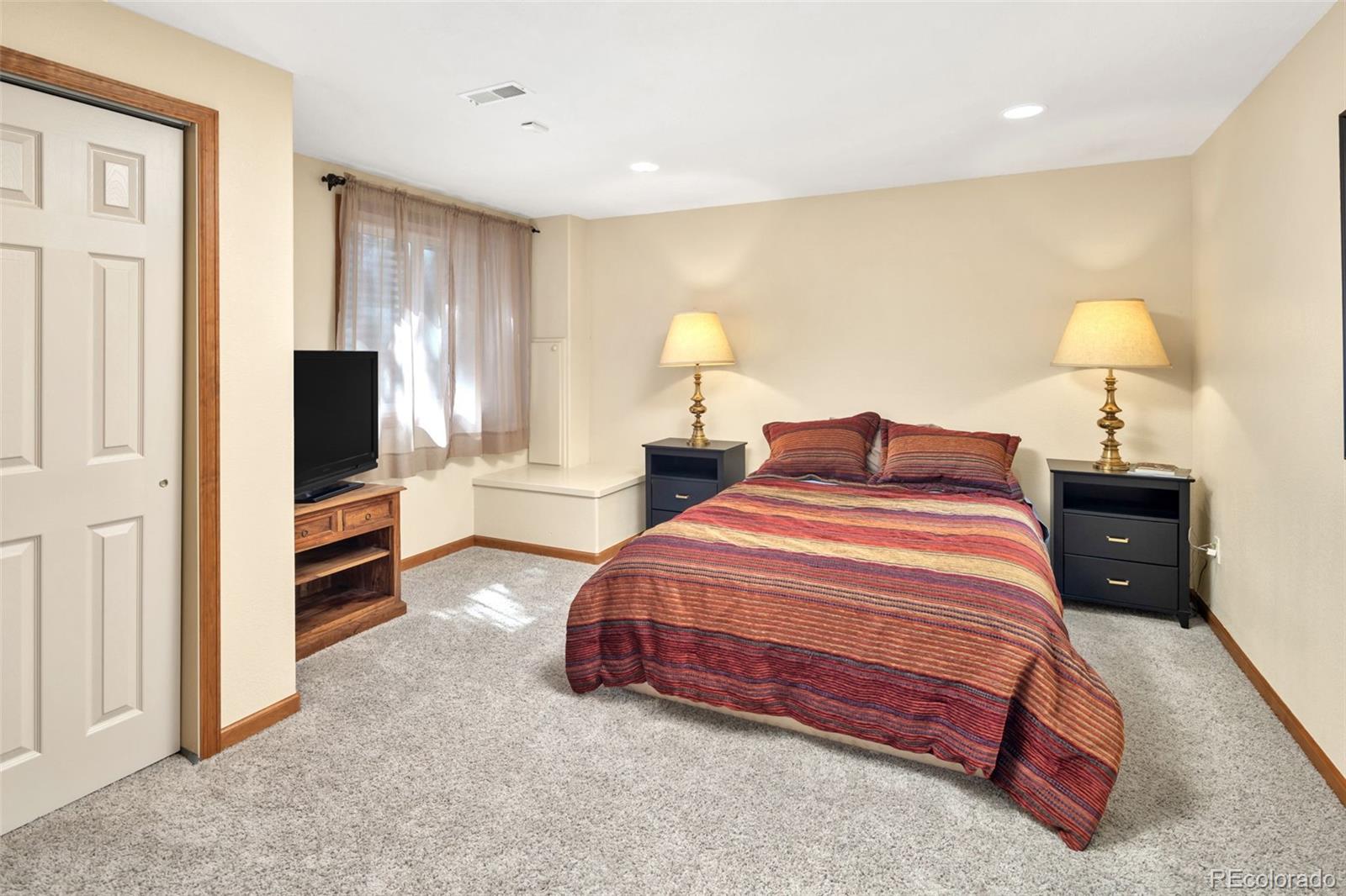 3816 Cloverleaf Drive Boulder, CO 80304 - Photo 25 of 35 a bedroom with a bed and a flat tv screen on wall