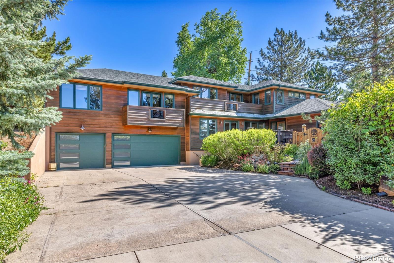3816 Cloverleaf Drive Boulder, CO 80304 - Photo 5 of 35 a front view of a house with a yard and a garage