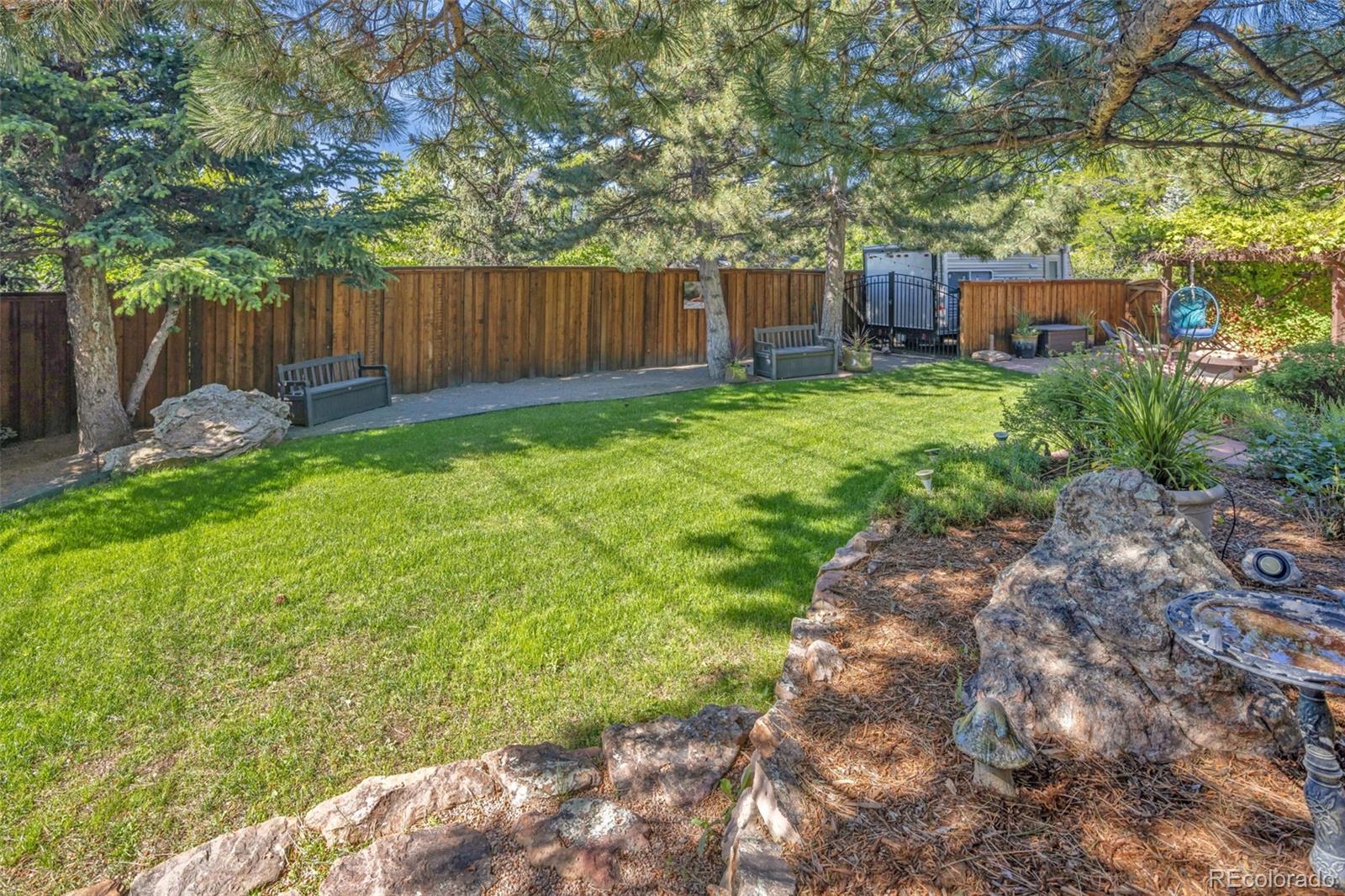 3816 Cloverleaf Drive Boulder, CO 80304 - Photo 8 of 35 a view of a backyard with a small cabin and wooden fence