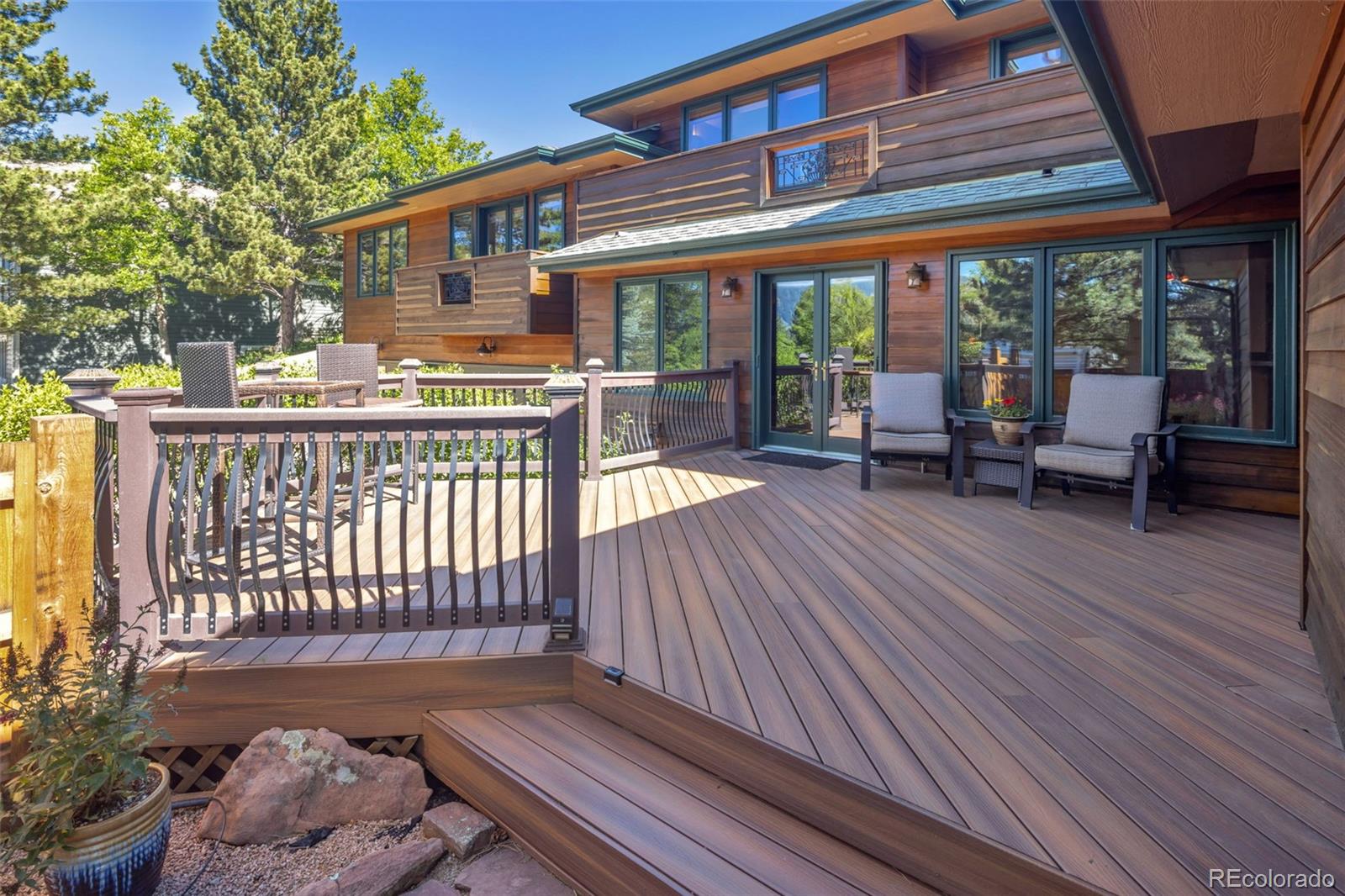 3816 Cloverleaf Drive Boulder, CO 80304 - Photo 9 of 35 a roof deck with table and chairs and wooden floor