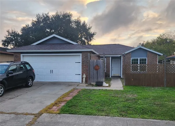 a front view of a house with a garden and yard