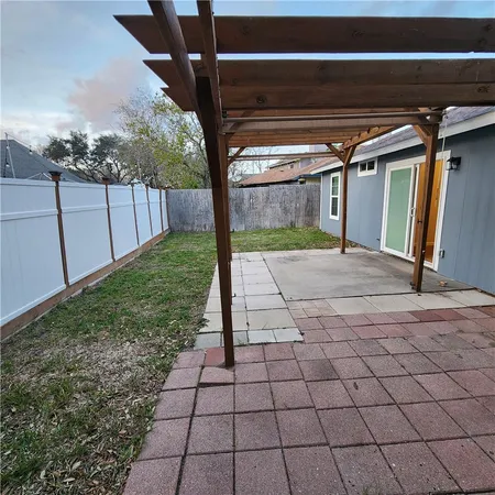 a view of a house with a backyard