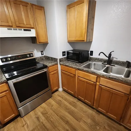 a kitchen with sink a microwave and stove