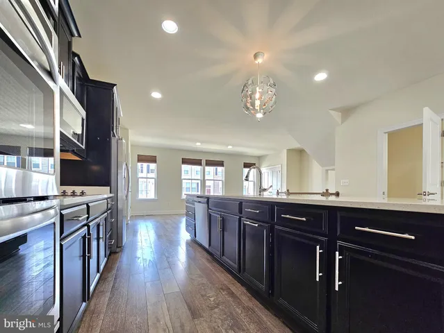 a large kitchen with lots of counter space a sink and appliances