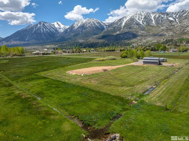 a aerial view of a house with swimming pool and lake view