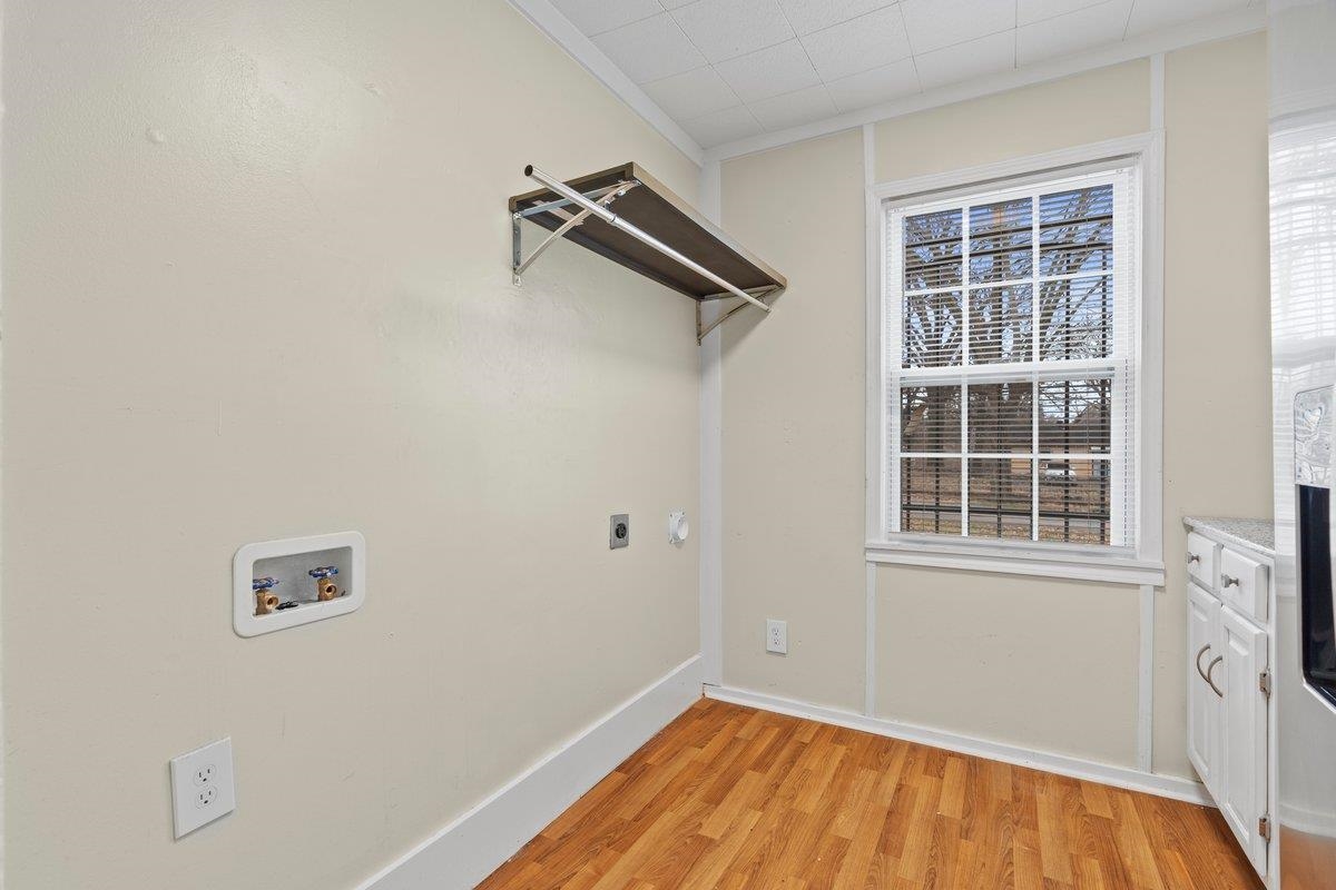 1012 Newell Road Memphis, TN 38111 - Photo 12 of 16 Washroom with electric dryer hookup, crown molding, light hardwood / wood-style flooring, hookup for a washing machine, and a wealth of natural light