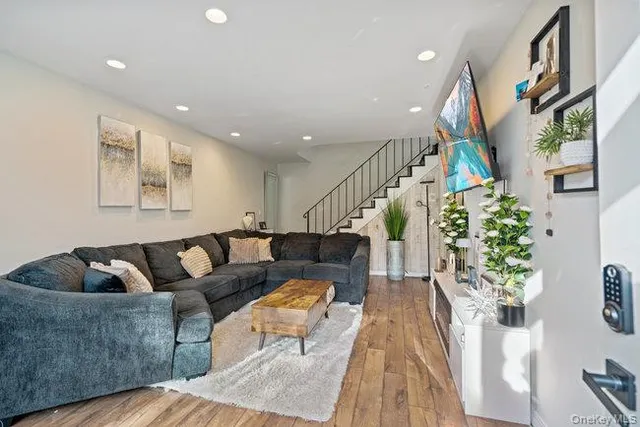 a living room with furniture and a potted plant