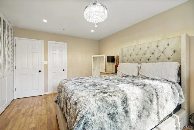 a spacious bedroom with a bed and a table