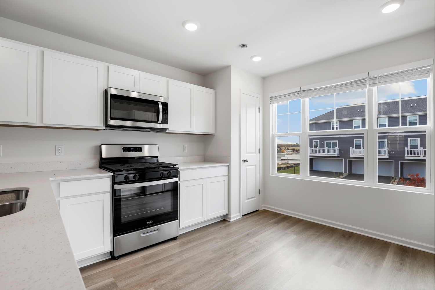 8746 Clover Lane St. John, IN 46373 - Photo 13 of 31 a kitchen with stainless steel appliances a stove microwave and sink