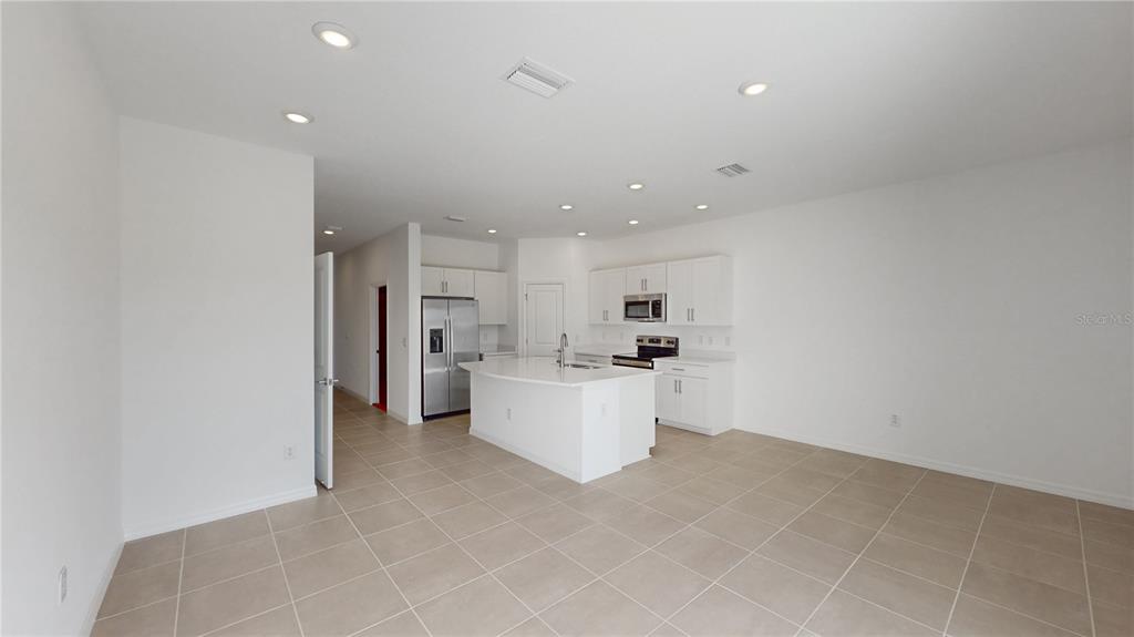 2415 Paravane Way Wesley Chapel, FL 33543 - Photo 12 of 23 a view of a kitchen with refrigerator and microwave
