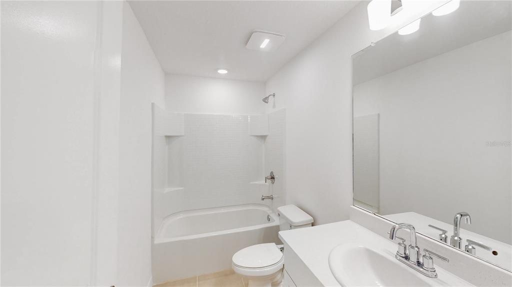 2415 Paravane Way Wesley Chapel, FL 33543 - Photo 14 of 23 a bathroom with a toilet a sink and bathtub