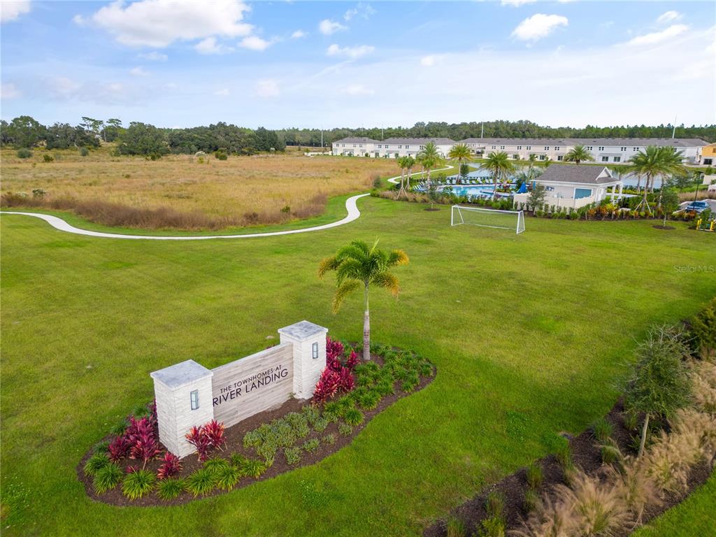 2415 Paravane Way Wesley Chapel, FL 33543 - Photo 16 of 23 a view of a lake with a building in the background