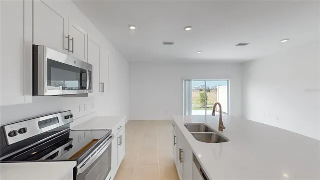 a kitchen with a sink and a stove top oven
