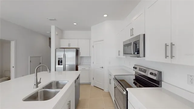 a kitchen that has a sink and a stove