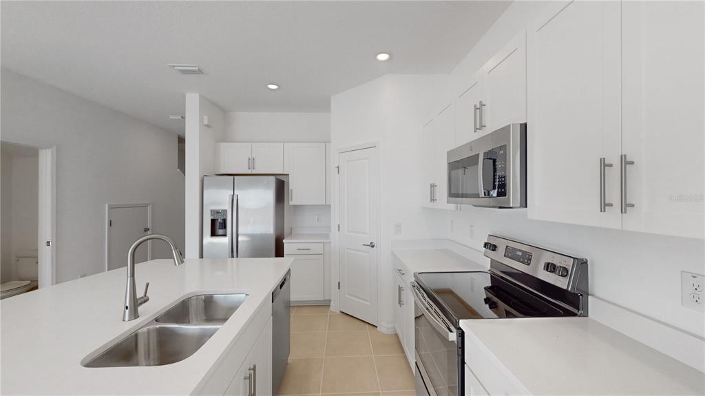 2415 Paravane Way Wesley Chapel, FL 33543 - Photo 5 of 23 a kitchen that has a sink and a stove