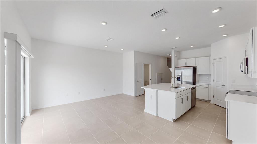 2415 Paravane Way Wesley Chapel, FL 33543 - Photo 7 of 23 a large white kitchen with a stove top oven a sink and dishwasher