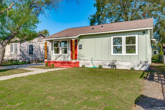 a view of a house with a yard and sitting area