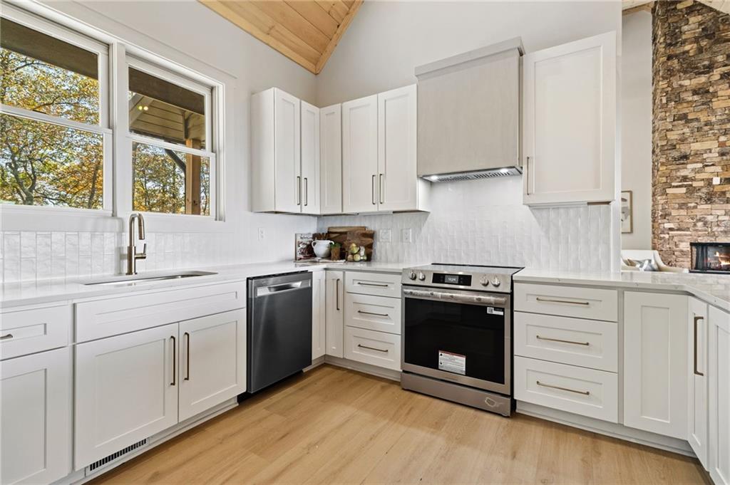 5388 Monument Road Jasper, GA 30143 - Photo 11 of 45 a kitchen with white cabinets stainless steel appliances and sink