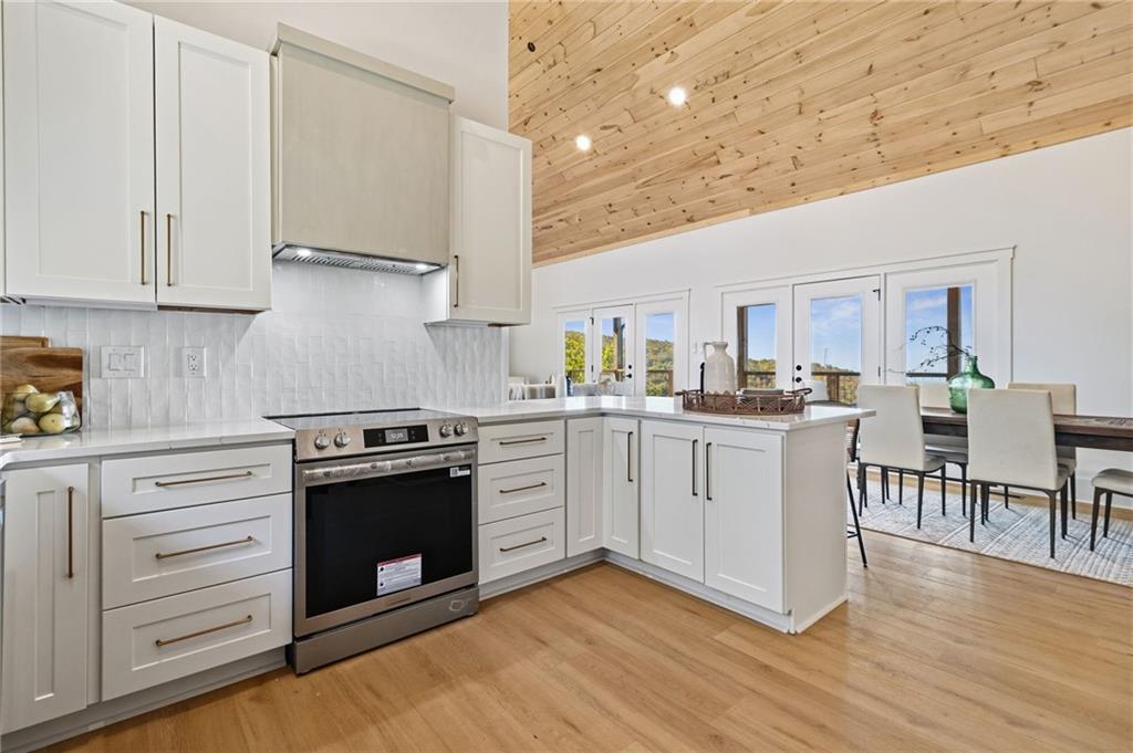 5388 Monument Road Jasper, GA 30143 - Photo 12 of 45 a kitchen with white cabinets and white appliances