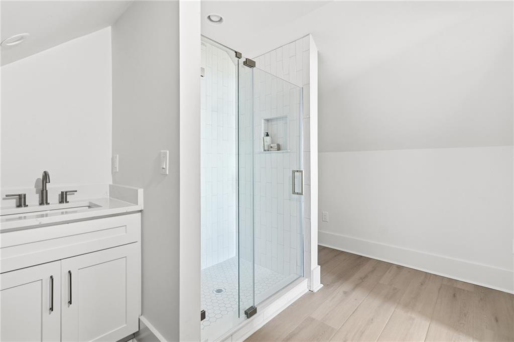 5388 Monument Road Jasper, GA 30143 - Photo 22 of 45 a bathroom with a granite countertop sink mirror and shower