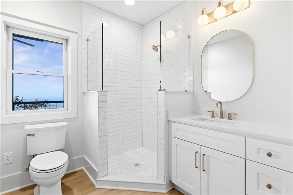5388 Monument Road Jasper, GA 30143 - Photo 24 of 45 a bathroom with a toilet a sink and mirror