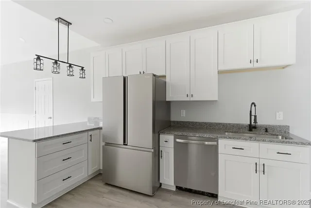 a kitchen with appliances cabinets and a sink