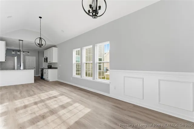 a view of a kitchen with dishwasher and white cabinets