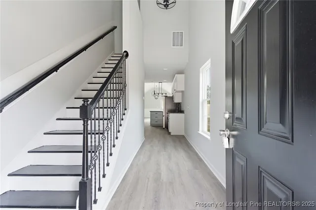 a view of entryway and hall with wooden floor