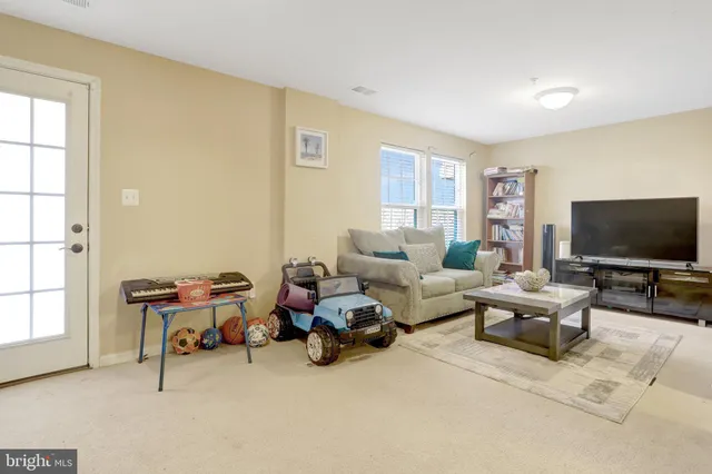 a living room with furniture a couch and a window