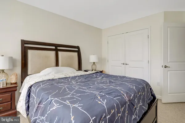 a bedroom with bed chair and window