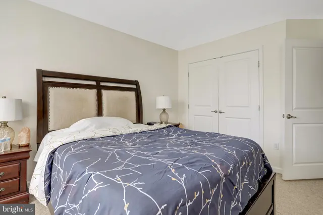 a bedroom with bed chair and window