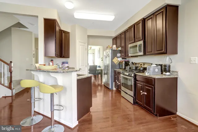 a view of a dining room with furniture and a chandelier