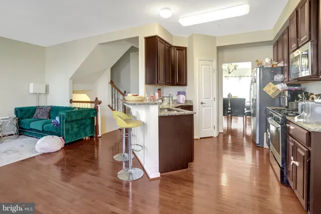 a view of a dining room with furniture and wooden floor