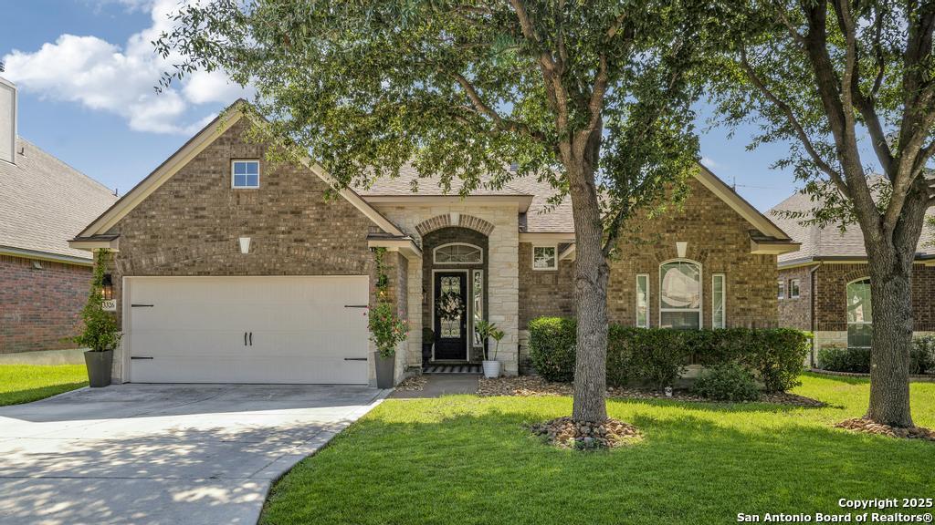 13326 Windmill Trace Helotes, TX 78023 - Photo 2 of 34 a front view of a house with garden
