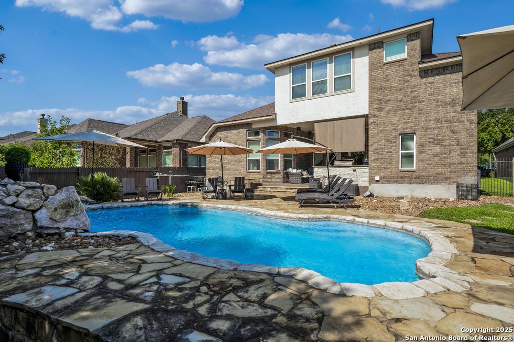 13326 Windmill Trace Helotes, TX 78023 - Photo 33 of 34 a view of a house with swimming pool and sitting area